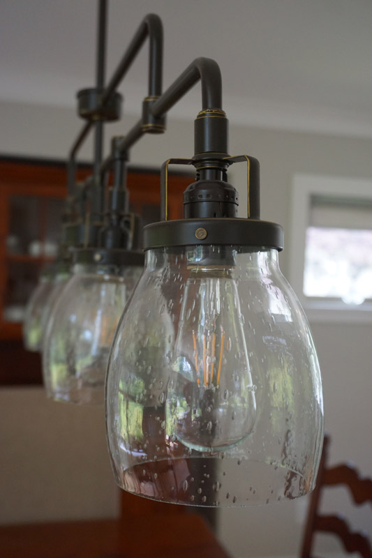 Curved and clear seeded glass shades complete the look with a hint of vintage inspiration.
