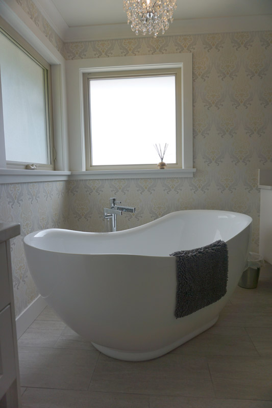 A distinct, tapered shape makes this freestanding tub a focal point in the master bath.