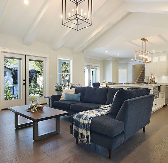 Vaulted ceilings and ceiling beams in the great room combine traditional design elements with a classic bright living space.