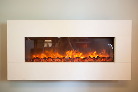 This wall mount electric fireplace made of limestone completes the area and spills warmth.
